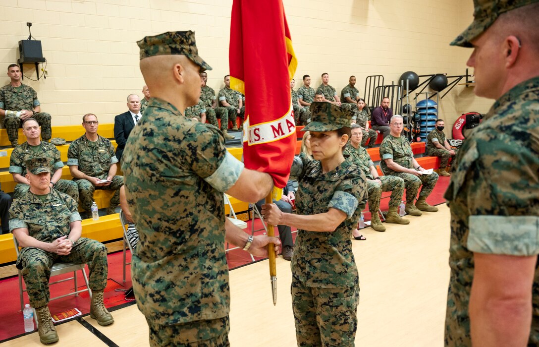 NORFOLK, Virginia (June 4, 2021) -- U.S. Marine Corps Col. Gabrielle M. Hermes assumes command of Headquarters and Service Battalion, Fleet Marine Force Atlantic, U.S. Marine Corps Forces Command, U.S. Marine Corps Forces Northern Command from U.S. Marine Corps Col. Mark R. Reid during a change of command ceremony at the Camp Elmore Gymnasium in Norfolk, Virginia. The passing of colors is performed at change of command ceremonies to symbolize the transfer of command authority and responsibility from the incumbent commanding officer to the new commanding officer. (U.S. Marine Corps photo by Jonathan Donnelly/Released)
