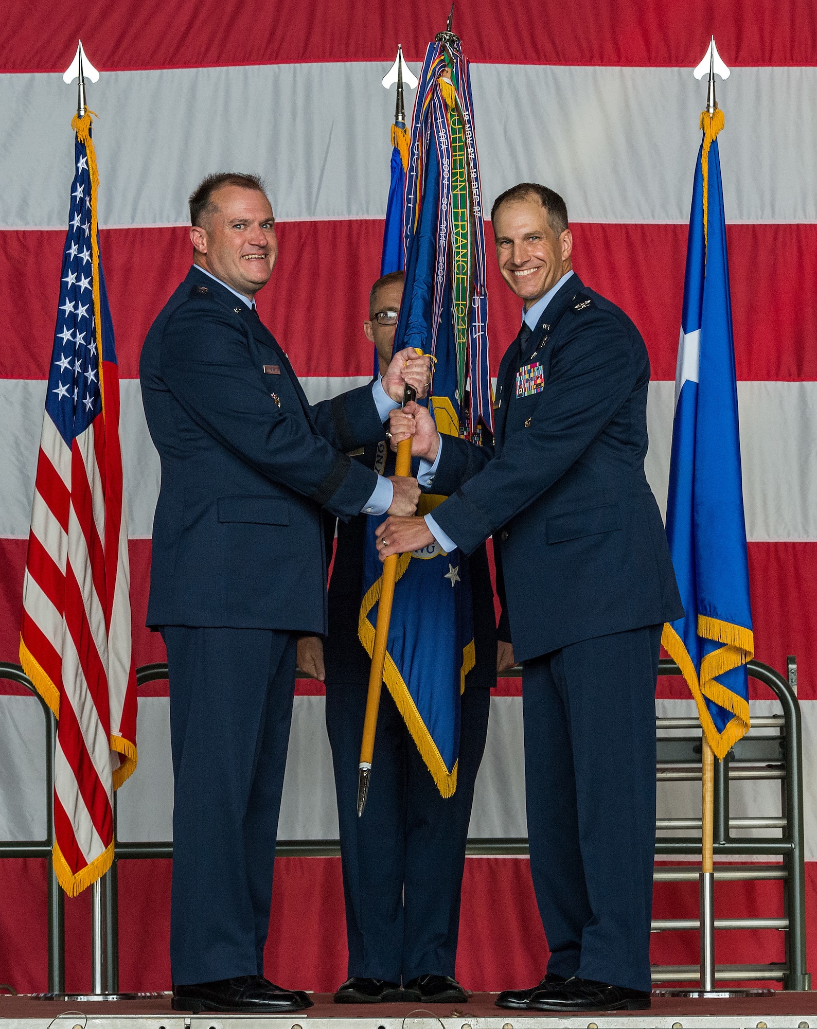 Maj. Gen. Thad Bibb, left, 18th Air Force commander, presents the 436th Airlift Wing guidon to Col. Matthew Husemann, 436th AW commander, during an assumption of command ceremony on Dover Air Force Base, Delaware, June 4, 2021. Upon taking command, Husemann became the wing’s 36th commander. (U.S. Air Force photo by Roland Balik)