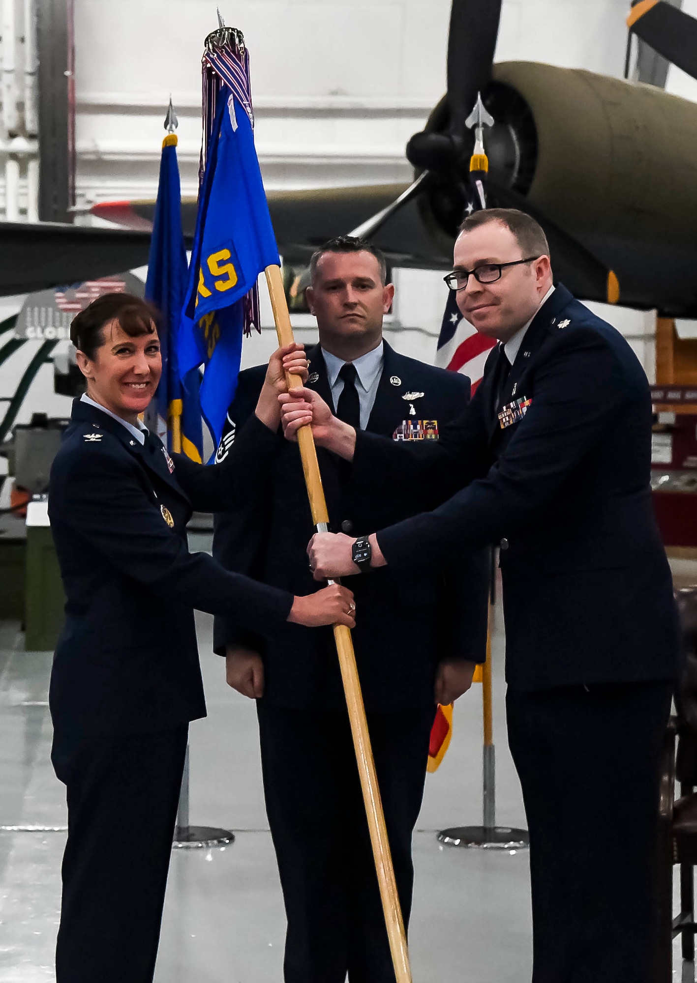 Lt. Col. Andrew Rees, right, outgoing 436th Operational Medical Readiness Squadron commander, passes the guidon to Col. Tracy Allen, 436th Medical Group commander, during a change of command ceremony on Dover Air Force Base, Delaware, May 27, 2021. The ceremony saw Rees relinquish command to Lt. Col. Kristen Nichols. (U.S. Air Force photo by Airman 1st Class Stephani Barge)