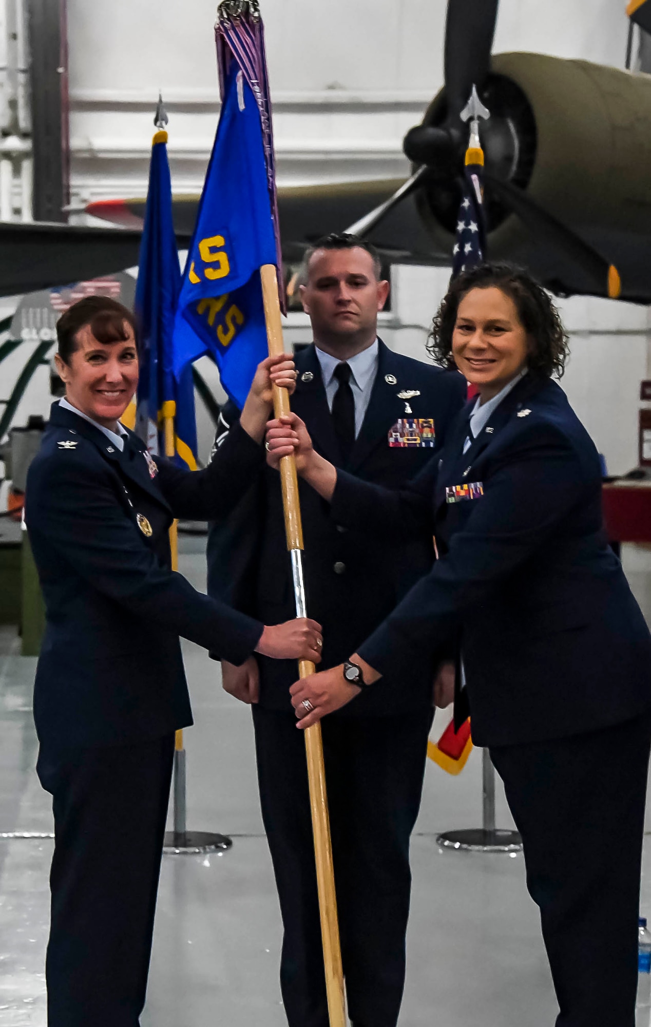 Col. Tracy Allen, left, 436th Medical Group commander, passes the guidon to Lt. Col. Kristen Nichols during the 436th Operational Medical Readiness Squadron change of command ceremony on Dover Air Force Base, Delaware, May 27, 2021. The ceremony saw Lt. Col. Andrew Rees relinquish command to Nichols. (U.S. Air Force photo by Airman 1st Class Stephani Barge)