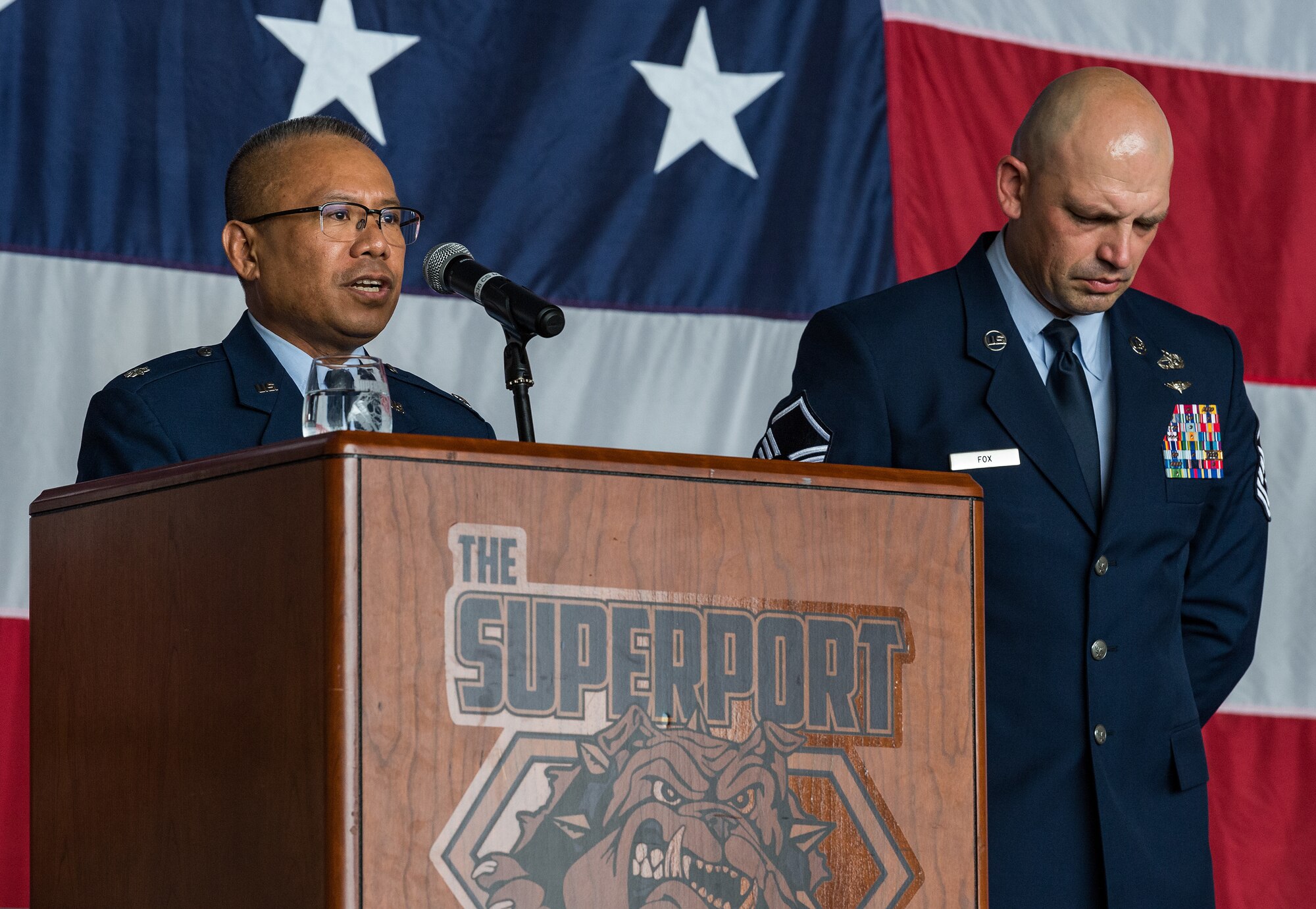 Lt. Col. Abner Valenzuela, left, 436th Airlift Wing chaplain, gives the invocation during the 436th AW Assumption of Command ceremony on Dover Air Force Base, Delaware, June 4, 2021. Upon taking command, Col. Matthew Husemann became the wing’s 36th commander. Standing next to Valenzuela is Master Sgt. Jason Fox, 436th Aerial Port Squadron passenger services and fleet operations superintendent, who served as the ceremony narrator. (U.S. Air Force photo by Roland Balik)