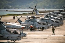 Helicopters attached to Marine Light Attack Helicopter Squadron 367 and Marine Heavy Helicopter Squadron 463 line up for a joint squadron training flight, Marine Corps Base Hawaii, May 27, 2021. The flight was conducted with the intent to increase readiness and promote interoperability between the two squadrons. (U.S. Marine Corps photo by Lance Cpl. Brandon Aultman)