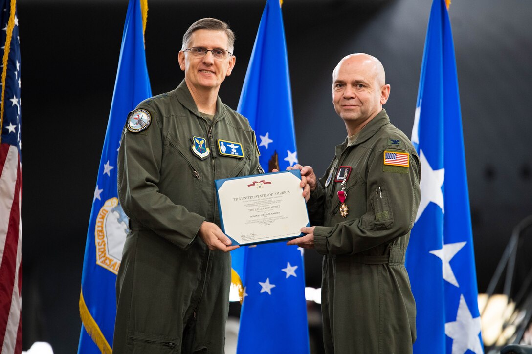 Col. Craig M. Ramsey, right, outgoing U.S. Air Force Nuclear Command, Control and Communications commander, receives the Legion of Merit from Gen. Timothy M. Ray, Air Force Global Strike Command commander, during the AFNC3 deactivation ceremony at Barksdale Air Force Base, Louisiana, June 4, 2021. The Legion of Merit is awarded for exceptionally meritorious conduct in the performance of outstanding services and achievements. (U.S. Air Force photo by Senior Airman Jacob B. Wrightsman)