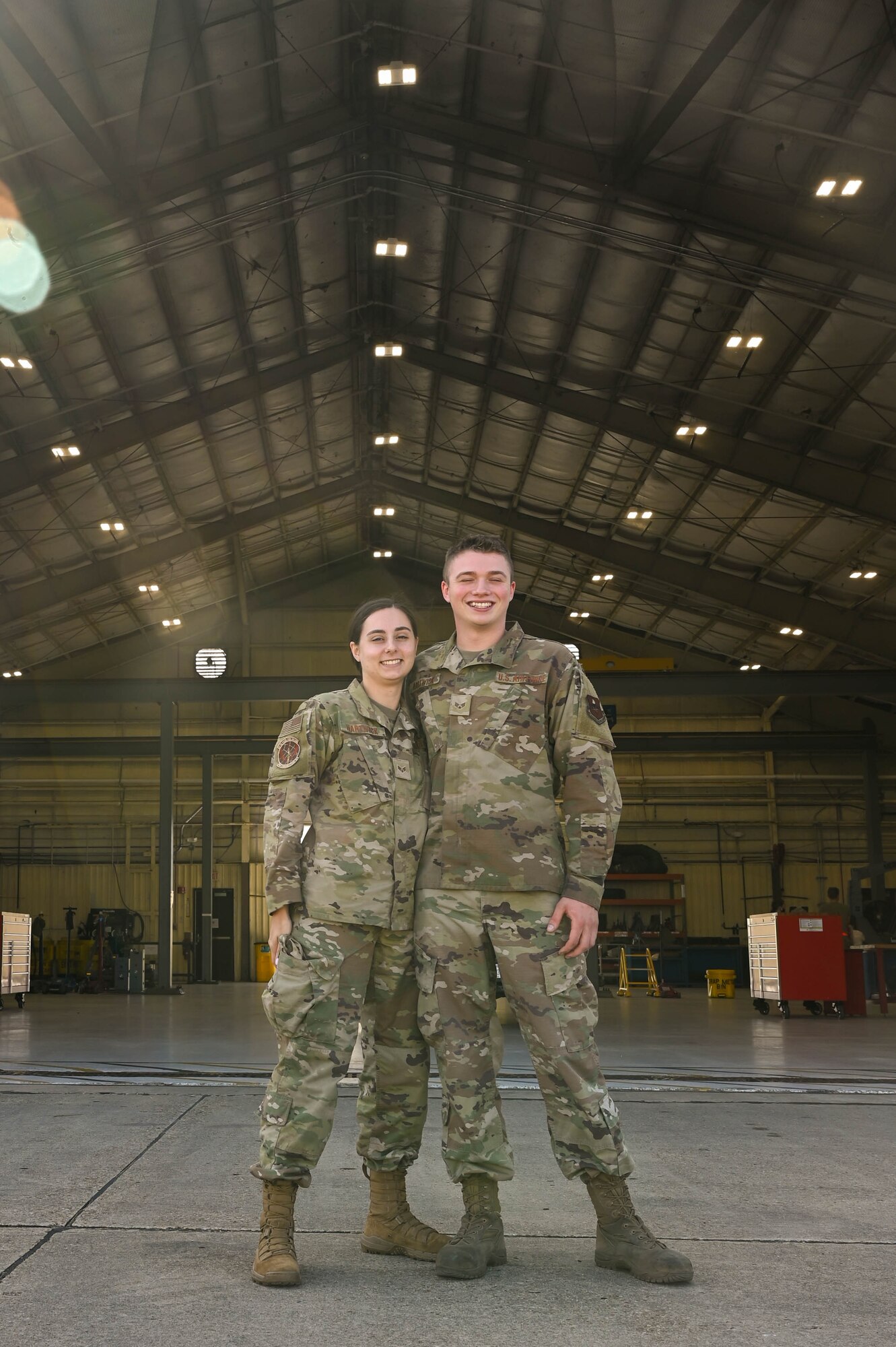 Airman poses with his spouse.