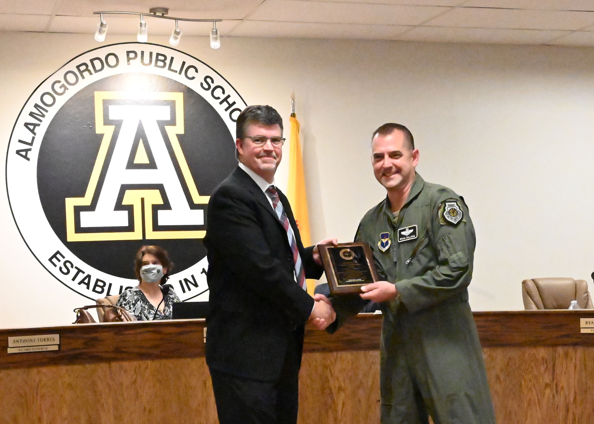 Ryan Sherwood, left, Alamogordo Public School Board vice president, presents Col. Bryan Callahan, 49th Wing vice commander, with the New Mexico School Board Association Student Achievement Award, May 19, 2021, in Alamogordo, New Mexico. Throughout his tenure, Callahan worked alongside school board members to bring improvements to both Holloman Air Force Base and the Alamogordo community. (U.S. Air Force photo by Shelley Bailey)