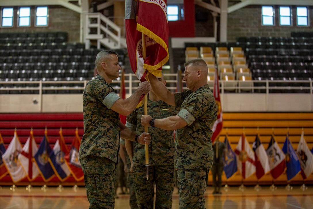 U.S. Marine Corps Maj. Gen. Julian D. Alford, right, outgoing commanding general, Marine Corps Installations East-Marine Corps Base Camp Lejeune, passes the organizational colors to Brig. Gen. Andrew M. Niebel, right, incoming commanding general for MCIEAST-MCB Camp Lejeune, during the change of command ceremony on MCB Camp Lejeune, North Carolina, June 4, 2021. (U.S. Marine Corps photo by Lance Cpl. Isaiah Gomez)