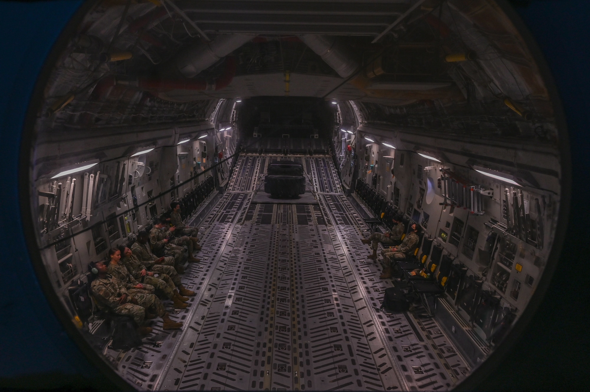 Team McChord Airmen await takeoff in a C-17 Globemaster III at Joint Base Lewis-McChord, Washington, June 2, 2021. These Airmen participated in an orientation flight as part of the Airmen Experience, a two-day immersive program that connects Airmen to the mission, allowing them to see firsthand how their role contributes to the bigger picture at JBLM. (U.S. Air Force photo by Airman 1st Class Callie Norton)
