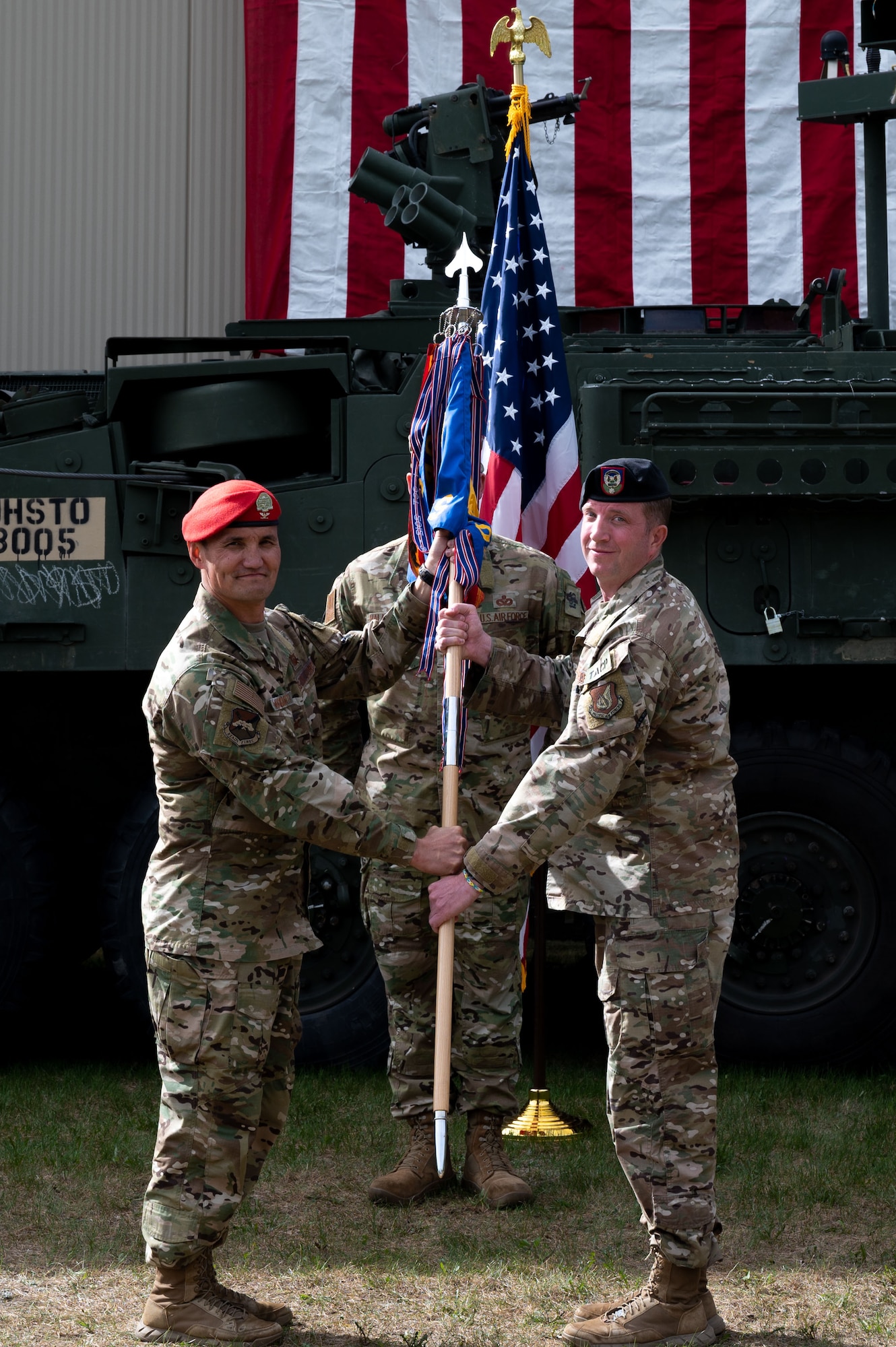 U.S. Air Force Col. Travis Woodworth (left), the 1st Air Support Operations Group commander, passes the 3rd Air Support Operations Squadron (ASOS) guidon to Lt. Col. Kyle Mattie, the 3rd ASOS commander, during a change of command ceremony at Fort Wainwright, Alaska, June 4, 2021.