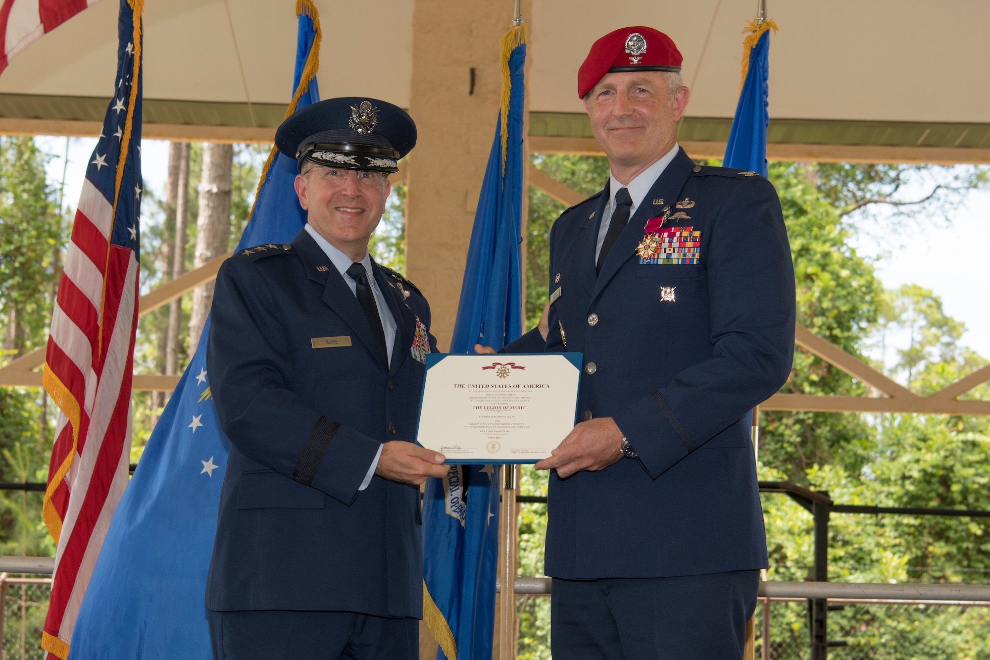 U.S. Air Force Col. Matthew Allen, outgoing commander of the 24th Special Operations Wing, receives the Legion of Merit from U.S. Air Force Lt. Gen. Jim Slife, commander of Air Force Special Operations Command, during a change of command ceremony at Hurlburt Field, Florida, June 4, 2021.
