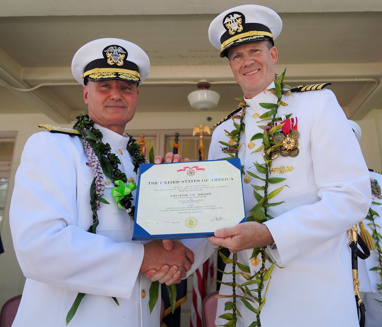 Pearl Harbor, Hawaii (June 4, 2021) Vice Admiral William J. Galinis, commander, Naval Sea Systems Command, presents Captain Greg Burton, outgoing commander of Pearl Harbor Naval Shipyard and Intermediate Maintenance Facility (PHNSY & IMF), with the Legion of Merit for outstanding service and commitment to duty during his four-year tour as shipyard commander. The award, typically reserved for senior officers, is given for exceptionally meritorious conduct in the performance of outstanding services and achievements. PHNSY & IMF is a field activity of NAVSEA and a one-stop regional maintenance center for the Navy’s surface ships and submarines. (U.S. Navy photo by Justice Vannatta/Released)