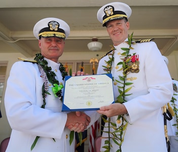 Pearl Harbor, Hawaii (June 4, 2021) Vice Admiral William J. Galinis, commander, Naval Sea Systems Command, presents Captain Greg Burton, outgoing commander of Pearl Harbor Naval Shipyard and Intermediate Maintenance Facility (PHNSY & IMF), with the Legion of Merit for outstanding service and commitment to duty during his four-year tour as shipyard commander. The award, typically reserved for senior officers, is given for exceptionally meritorious conduct in the performance of outstanding services and achievements. PHNSY & IMF is a field activity of NAVSEA and a one-stop regional maintenance center for the Navy’s surface ships and submarines. (U.S. Navy photo by Justice Vannatta/Released)