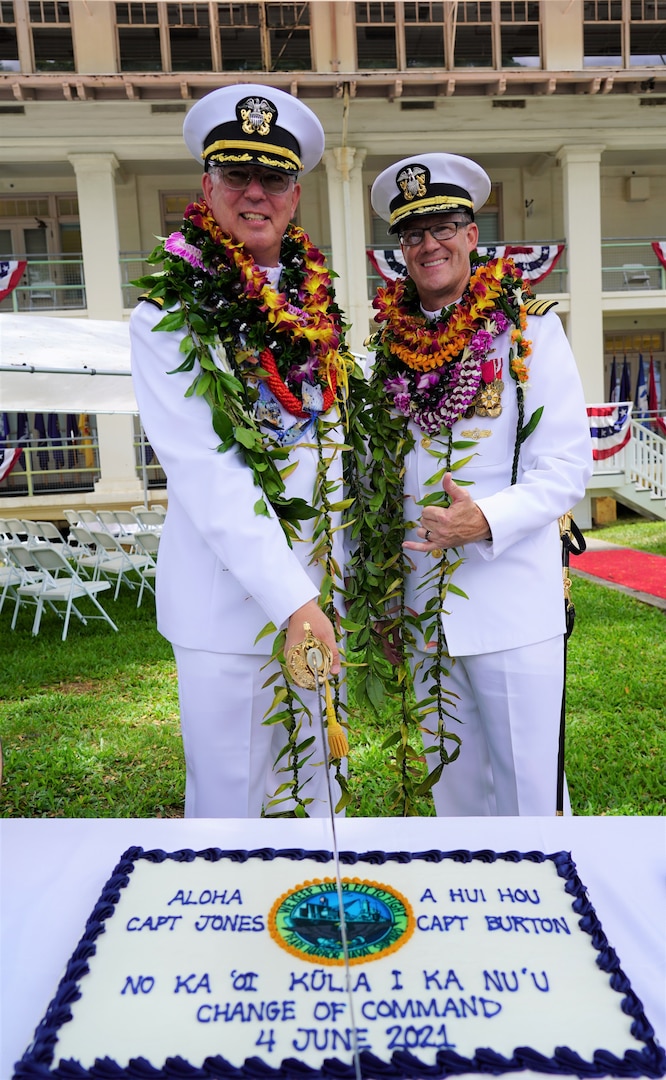 Pearl Harbor, Hawaii (June 4, 2021) Captain Richard Jones, commander, Pearl Harbor Naval Shipyard and Intermediate Maintenance Facility, and Captain Greg Burton cut the cake in celebration of Pearl Harbor Naval Shipyard and Intermediate Maintenance Facility (PHNSY & IMF) change of command ceremony. PHNSY & IMF is a field activity of NAVSEA and a one-stop regional maintenance center for the Navy’s surface ships and submarines. (U.S. Navy photo by Justice Vannatta/Released)