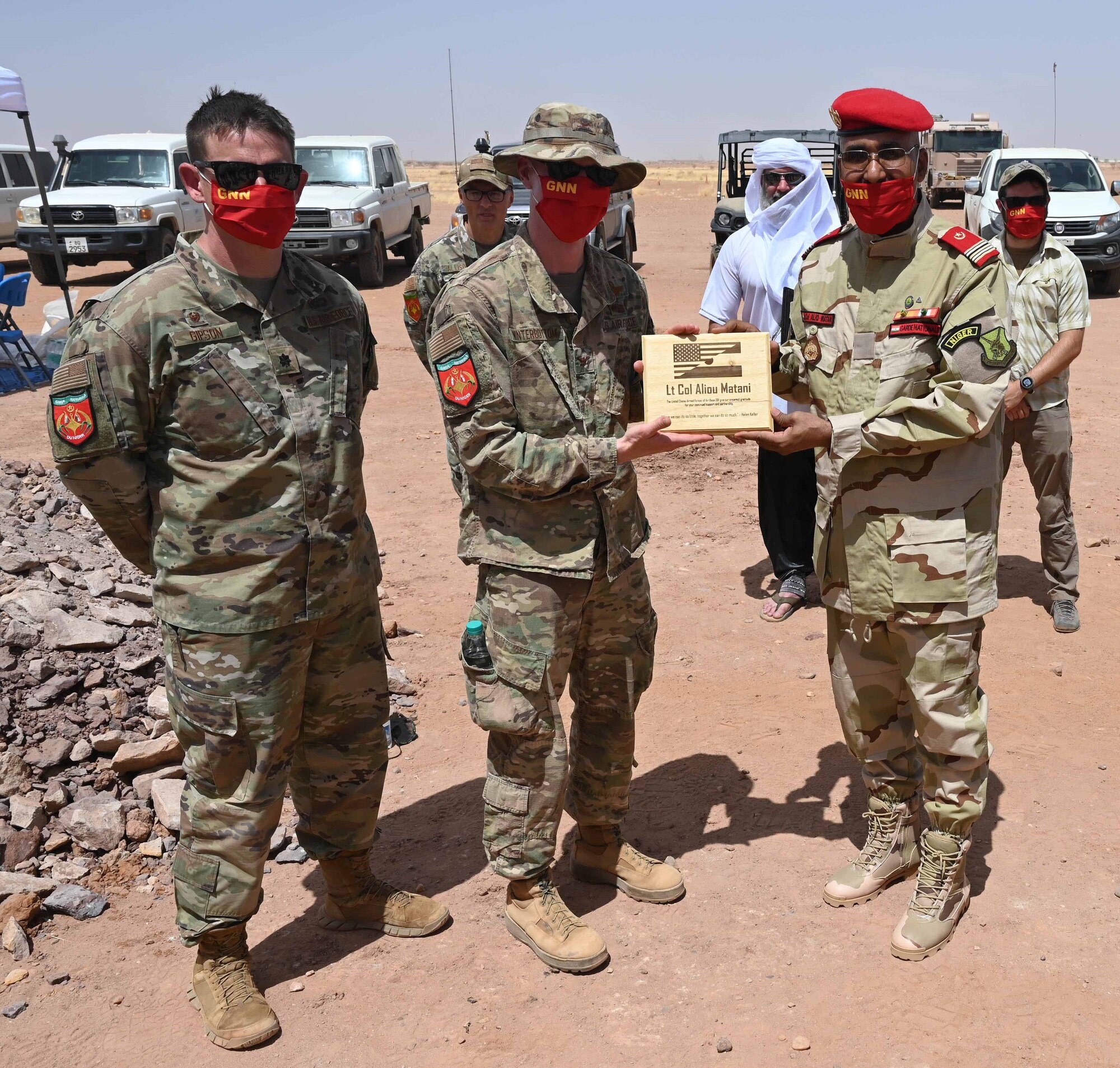 Col. Winterbottom and Lt. Col. Gipson (left) present a gift of appreciation to Nigerien National Guard Lt. Col. Aliou Matani at Nigerien Air Base 201, Agadez, Niger, May 31, 2021. Since 1990, the U.S. has provided $25 million dollars to help partnerships flourish in areas of law enforcement, border security, and civilian safety through counter-terrorism exchanges and equipment donation.