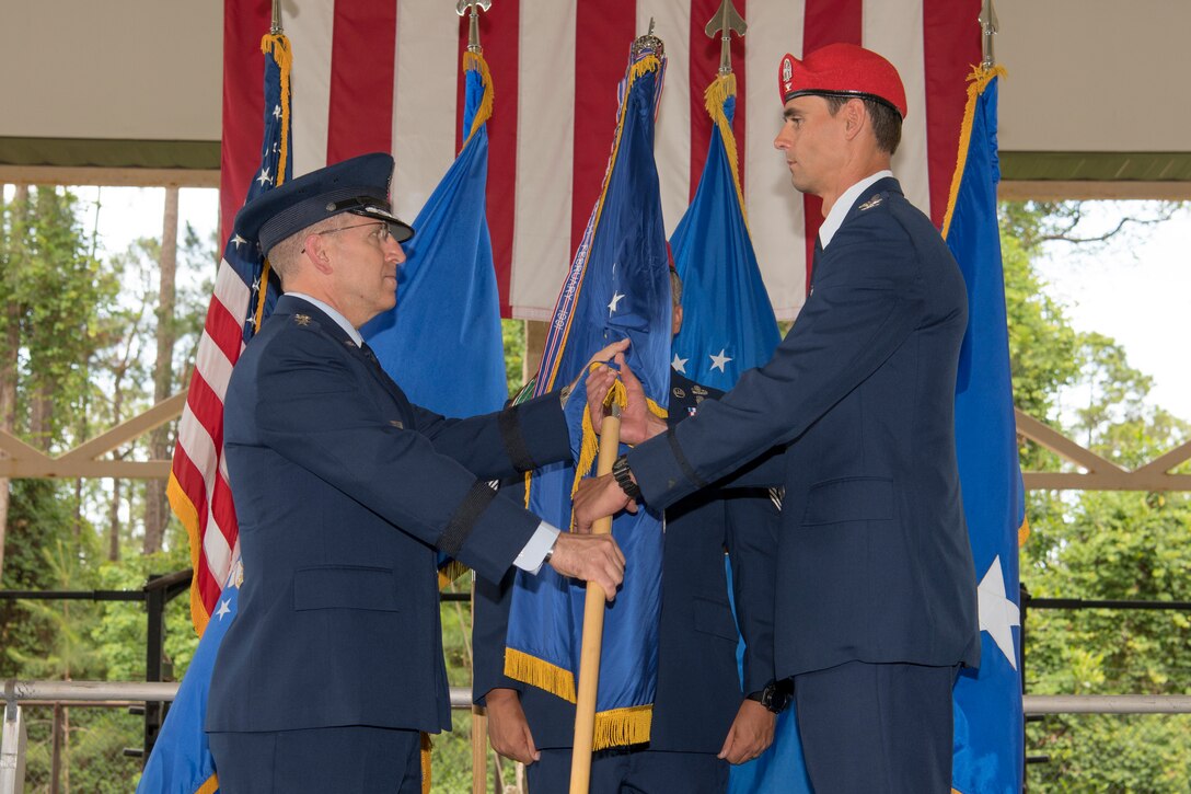 U.S. Air Force Col. Jason Daniels, right, accepts command of the 24th Special Operations Wing from U.S. Air Force Lt. Gen. Jim Slife, commander of Air Force Special Operations Command, during a change of command ceremony at Hurlburt Field, Florida, June 4, 2021.