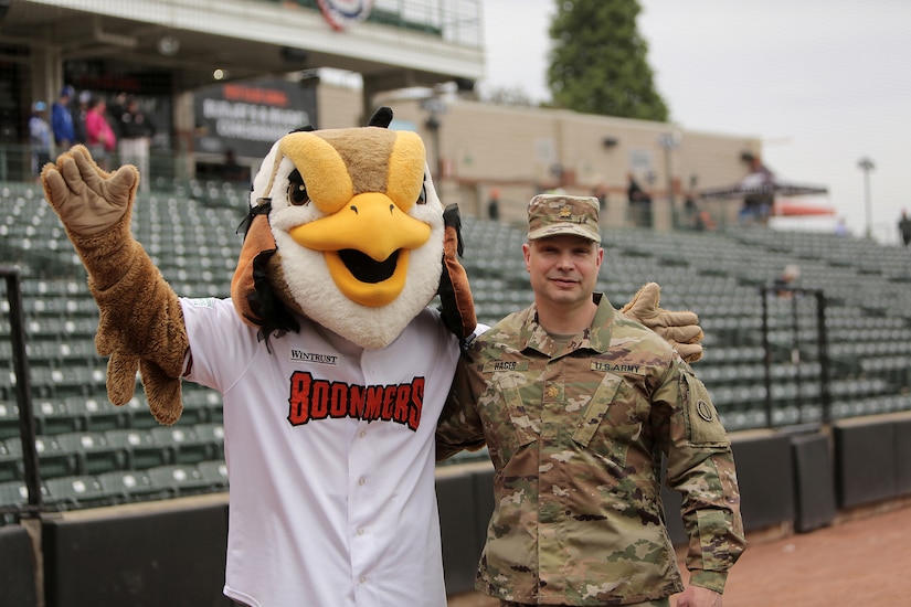 Maj. Scott Hager, Headquarters and Headquarters Company commander for the 85th U.S. Army Reserve Support Command, pauses for a photo with “Coop”, the Mascot for the Schaumburg Boomers baseball team, before the Boomers Memorial Day home game vs. the Gateway Grizzlies at Wintrust Field, May 31, 2021.