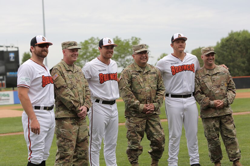 Soldiers assigned to the 85th U.S. Army Reserve Support Command headquarters pause for a photo with players from the Schaumburg Boomers baseball team, May 31, 2021, in Schaumburg, Illinois during a Memorial Day home game against the Gateway Grizzlies.