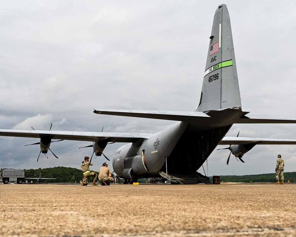 Airmen carefully load a Humvee and trailer onto a C-130J Super Hercules at Little Rock Air Force Base, Arkansas, June 5, 2021. ‘Port Dawgs’ from the 189th Aerial Port Flight, Air National Guard, and from the 96th Aerial Port Squadron, Air Force Reserve, created a joint training event at Little Rock Air Force Base, Arkansas, June 3-6, 2021. (U.S. Air Force photo by Maj. Ashley Walker)