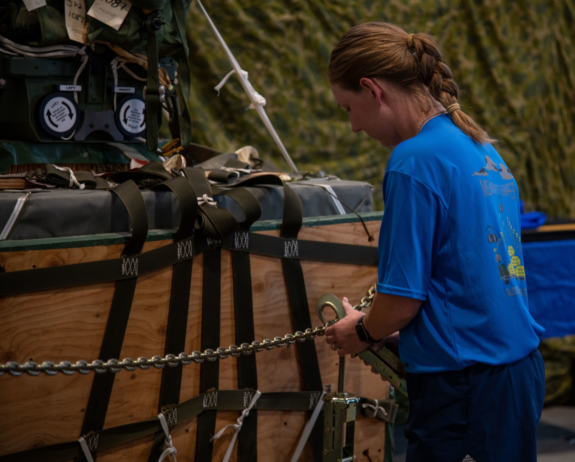 A member of the 41st Aerial Port squadron at Keesler Air Force Base, Miss., attaches a device to a chain, represent one of 12 members of the air transportation community who lost their life in 2020, during a memorial event June 5, 2021. This marked the first time the 41st APS held and participated in the “Port Dawg Memorial Run.” (U.S. Air Force Photo by Staff Sgt. Kristen Pittman)