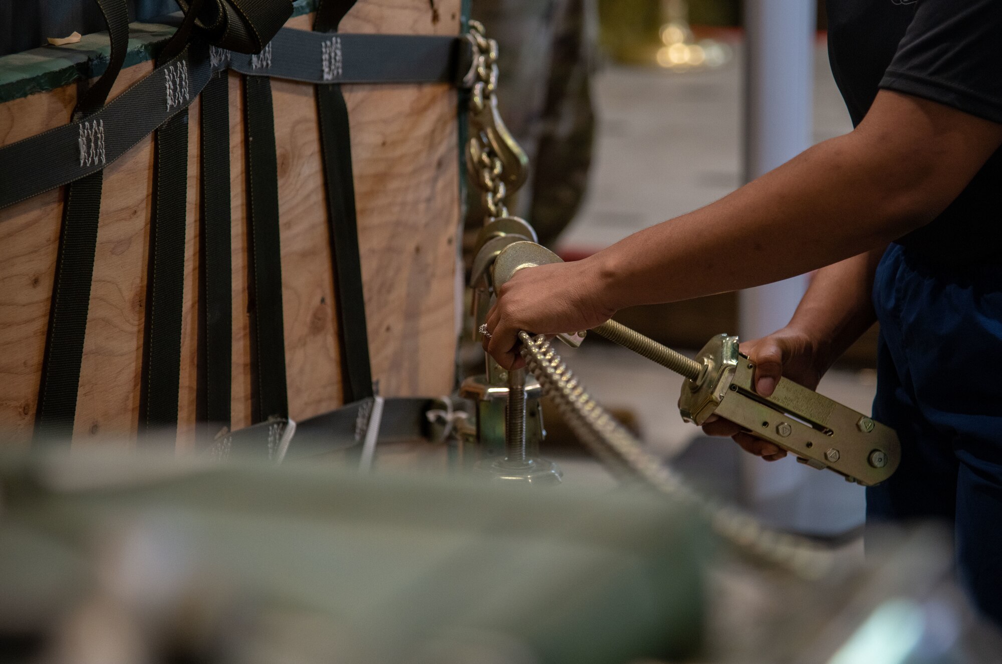 Senior Airman Jasmine Jordan of the 41st Aerial Port Squadron at Keesler Air Force Base, Miss., attaches a WHAT to a chain, represent one of 12 members of the air transportation community who lost their life in 2020, during a memorial event June 5, 2021. Jordan was one of the Reserve Citizen Airmen who helped organize the first annual (for the 41st) “Port Dawg Memorial Run” here. (U.S. Air Force Photo by Staff Sgt. Kristen Pittman)