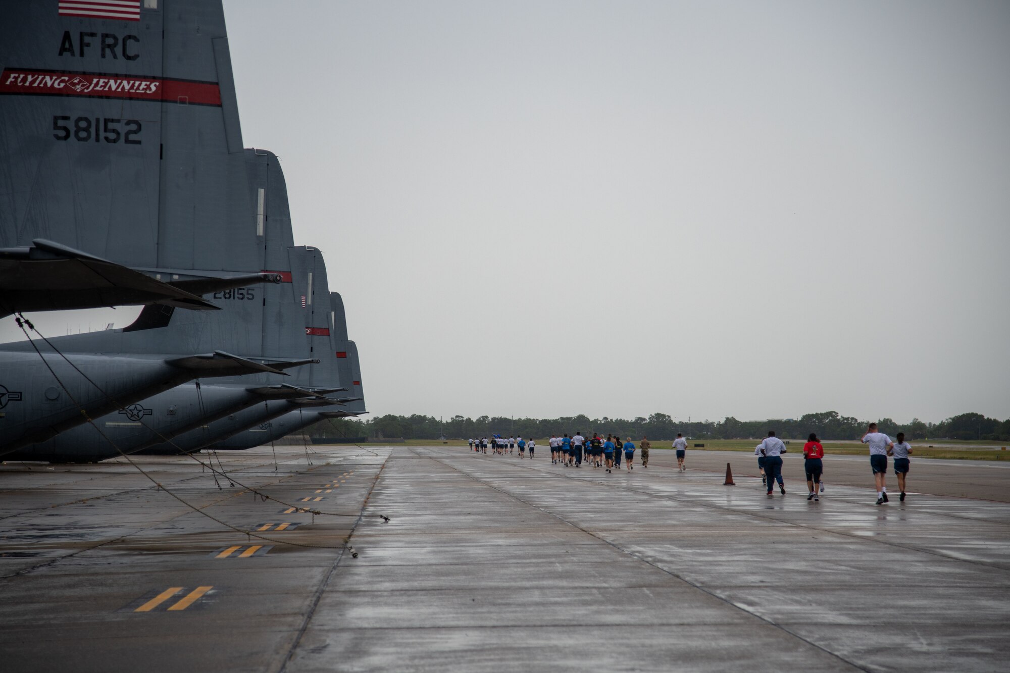 Members of the 41st Aerial Port Squadron at Keesler Air Force Base, Miss., participate in the “Port Dawg Memorial Run” on the Keesler flight line June 5, 2021. The event serves as a way for members to pay tribute to lives lost in the career-field across the entire Air Force. (U.S. Air Force Photo by Staff Sgt. Kristen Pittman)