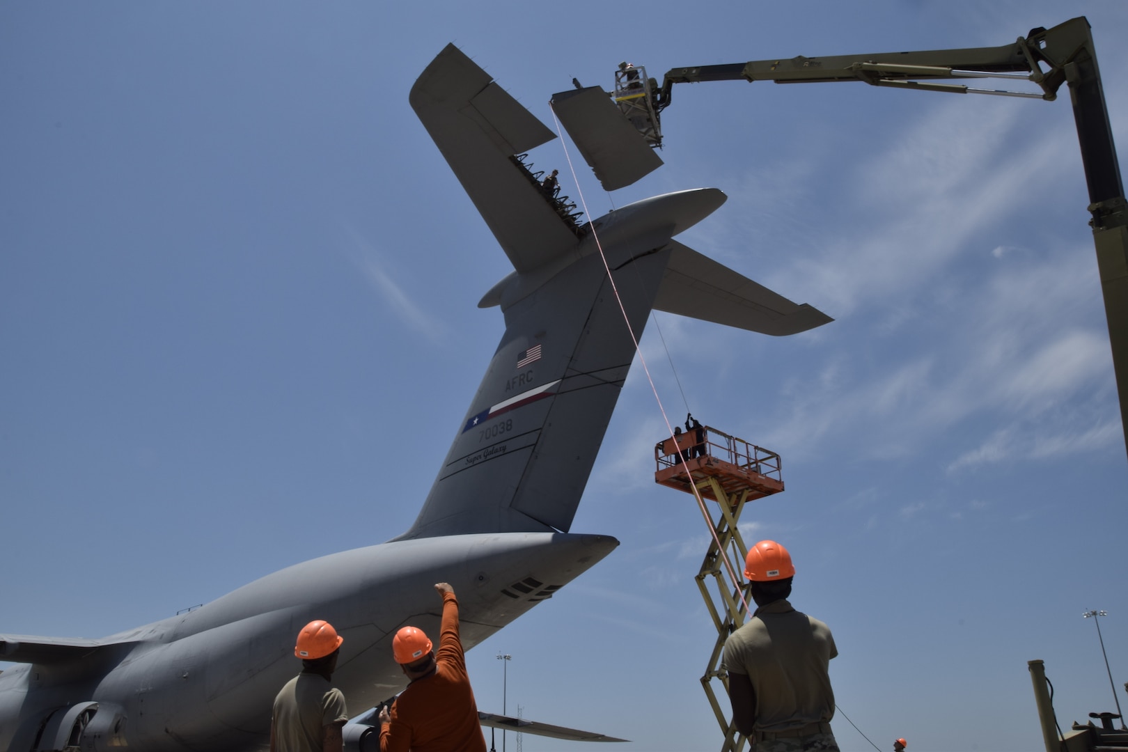 A 433rd Airlift Wing aircraft maintenance crew of 14 personnel work a rarely seen maintenance task on a C-5M Super Galaxy to remove the aircraft’s elevator May 20, 2021 at Joint Base San Antonio-Lackland, Texas. The job task was to remove the elevator to access a crack on the aircraft’s hull that needed repair. (Air Force photo by Senior Airman Brittany Wich)