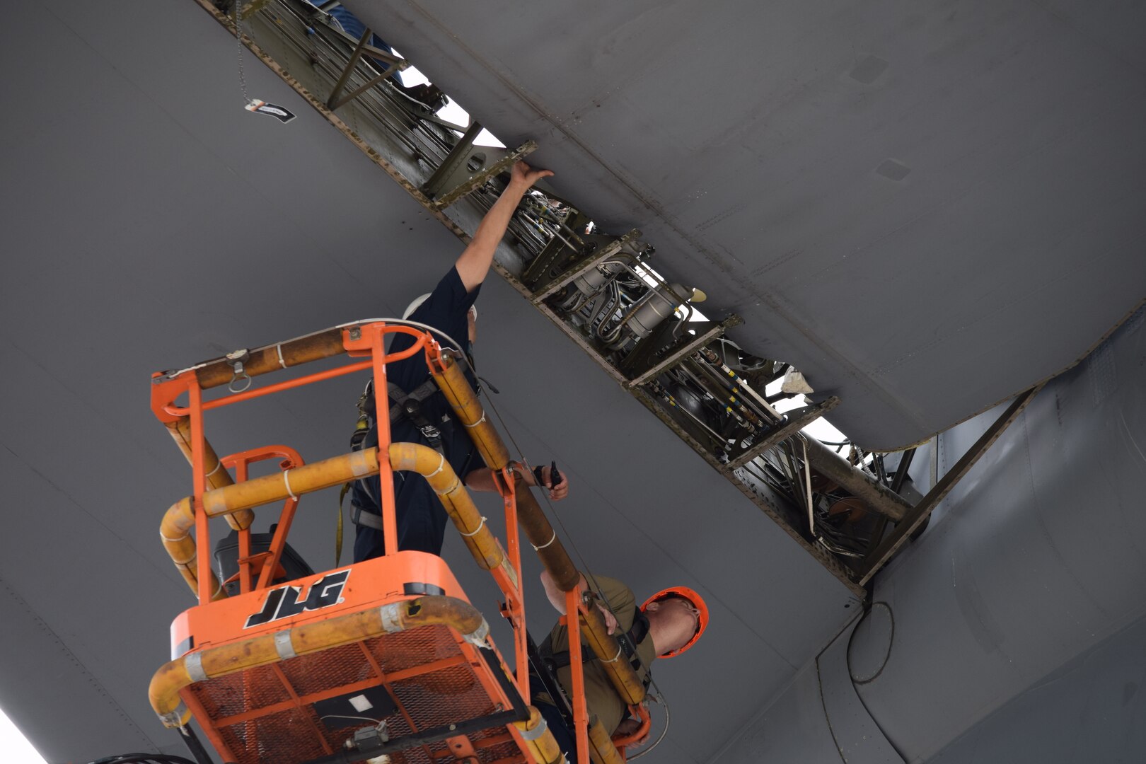 Staff Sgt. Reed Wilson and Senior Airman Justin Dunn, 433rd Airlift Wing aircraft maintainers, monitor a C-5M Super Galaxy elevator as it is being reinstalled onto the aircraft May 27, 2021 at Joint Base San Antonio-Lackland, Texas. The elevator was removed to allow repair of a crack on the aircraft’s hull. (Air Force photo by Tech. Sgt. Iram Carmona)