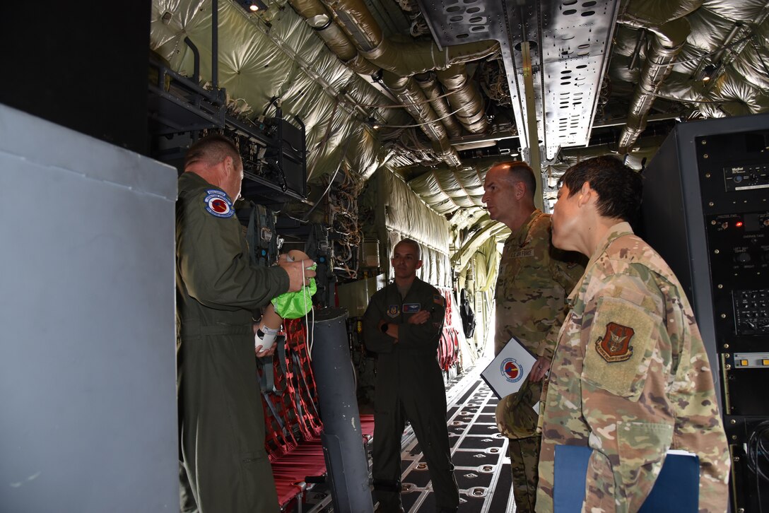 Maj. Gen. John Healy, 22nd Air Force commander, and Chief Master Sgt. Imelda Johnson, 22nd AF command chief master sergeant, received a briefing on the 53rd Weather Reconnaissance Squadron mission on the WC-130J Super Hercules by Maj. Jarod Hamblin, 53rd WRS pilot, and Senior Master Sgt. Joseph Latham, 53rd WRS loadmaster, during a visit to the 403rd Wing, June 4-5, 2021. The visit coincided with the 403rd Wing's change of command, in which Healy presided over the ceremony where Col. Stuart M. Rubio took command from Col. Jeffrey A. Van Dootingh, June 5. (U.S. Air Force photo by Jessica L. Kendziorek)