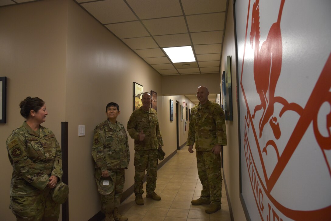 Maj. Gen. John Healy, 22nd Air Force commander, and Chief Master Sgt. Imelda Johnson, 22nd AF command chief master sergeant, talk with Col. Matthew Sikkink, 815th Airlift Squadron commander during their visit to the 403rd Wing, June 4-5, 2021. The visit coincided with the 403rd Wing's change of command, in which Healy presided over the ceremony where Col. Stuart M. Rubio took command from Col. Jeffrey A. Van Dootingh, June 5. (U.S. Air Force photo by Jessica L. Kendziorek)