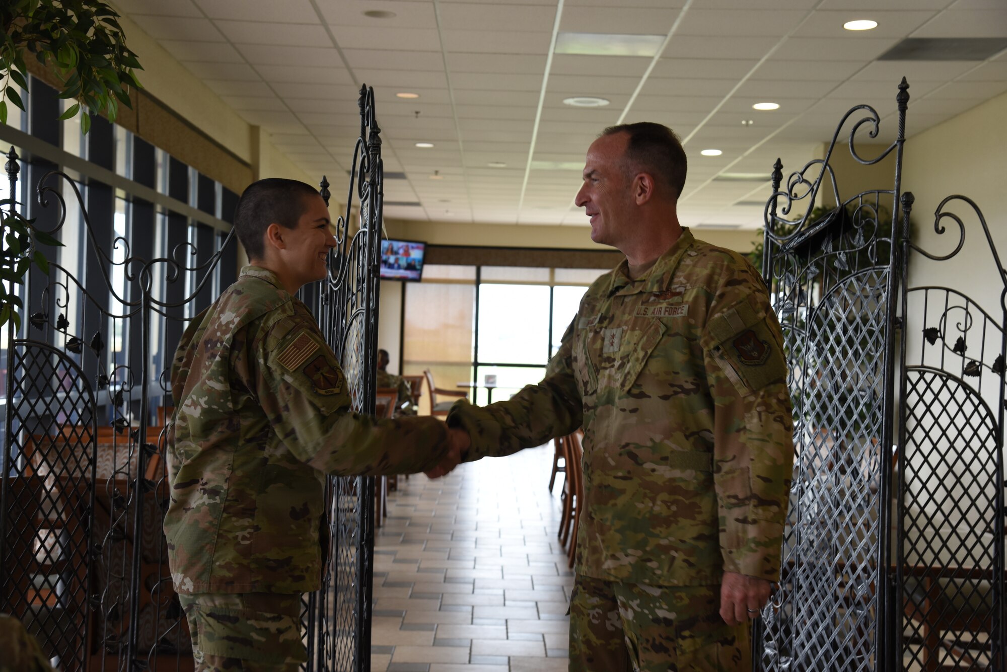 Maj. Gen. John Healy, 22nd Air Force commander, coined Staff Sgt. Kristen Pittman, 403rd Wing public affairs specialist, during lunch while Healy and Chief Master Sgt. Imelda Johnson, 22nd AF command chief master sergeant, while they were visiting the 403rd Wing June 4-5, 2021. The visit coincided with the 403rd Wing's change of command, in which Healy presided over the ceremony where Col. Stuart M. Rubio took command from Col. Jeffrey A. Van Dootingh, June 5. (U.S. Air Force photo by Jessica L. Kendziorek)