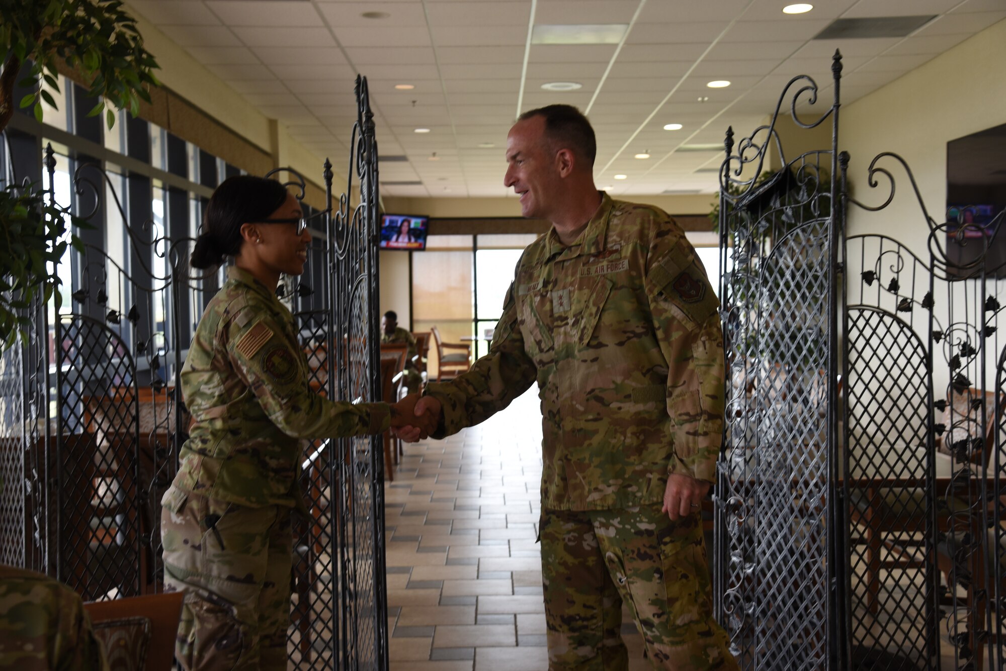 Maj. Gen. John Healy, 22nd Air Force commander, coined Staff Sgt. Courtney Alfred, 36th Aeromedical Evacuation Squadron medical readiness training, during lunch while Healy and Chief Master Sgt. Imelda Johnson, 22nd AF command chief master sergeant, while they were visiting the 403rd Wing June 4-5, 2021.  The visit coincided with the 403rd Wing's change of command, in which Healy presided over the ceremony where Col. Stuart M. Rubio took command from Col. Jeffrey A. Van Dootingh, June 5. (U.S. Air Force photo by Jessica L. Kendziorek)