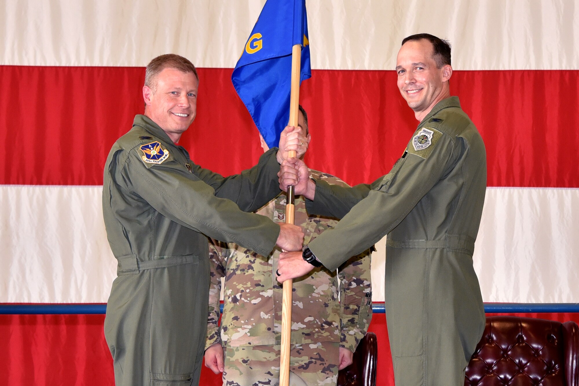 (left) Col. Allen Duckworth, 301st Fighter Wing commander, passes the guideon to Col. Benjamin Harrison, 301st Operations Group commander, June 6, 2021, at U.S. Naval Air Station Joint Reserve Base Fort Worth, Texas. The change of command ceremony is a time honored military tradition that signifies the transfer of authority from the out going commander to the new commander. (U.S. Air Force photo by Staff Sgt. Randall Moose)
