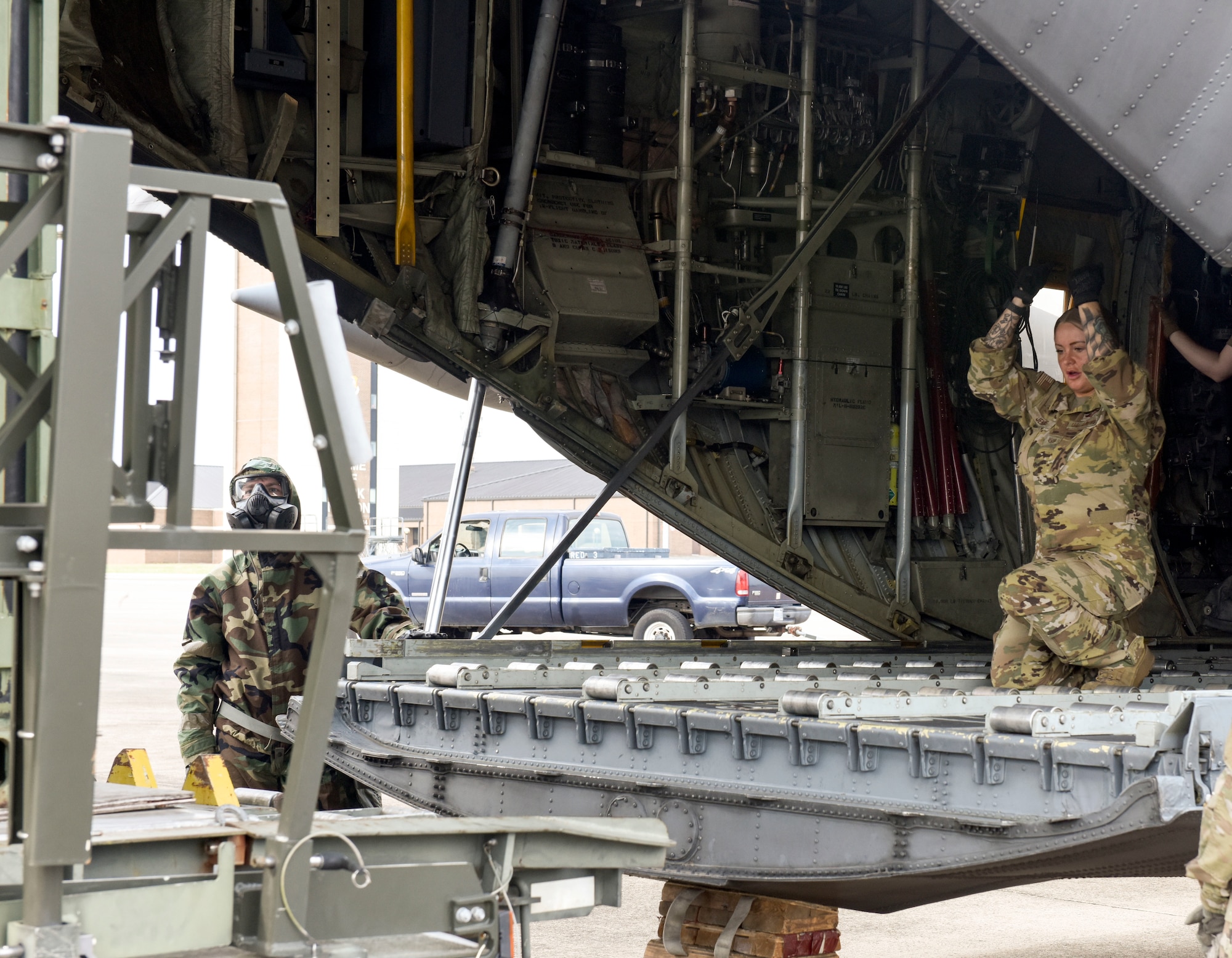 A loadmaster guides the K-loader to the ramp of a C-130H Hercules aircraft during the aerial port training event on June 5, 2021 at Little Rock Air Force Base, Arkansas. The ‘Port Dawgs’ from the 189th Aerial Port Flight, Air National Guard, and from the 96th Aerial Port Squadron, Air Force Reserve, created training focused on testing aerial port operations. (U.S. Air Force photo by Tech. Sgt. James Phillips)