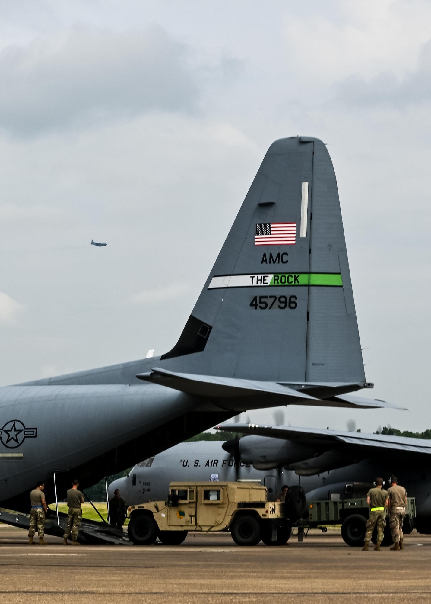 Airmen carefully load a Humvee and trailer onto a C-130J Super Hercules at Little Rock Air Force Base, Arkansas, June 5, 2021. ‘Port Dawgs’ from the 189th Aerial Port Flight, Air National Guard, and from the 96th Aerial Port Squadron, Air Force Reserve, created a joint training event at Little Rock Air Force Base, Arkansas, June 3-6, 2021. (U.S. Air Force photo by Maj. Ashley Walker)