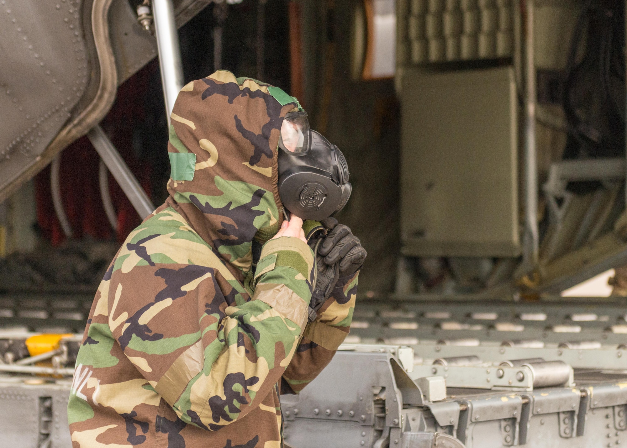 An Airman adjusts his gas mask and personal protective equipment at Little Rock Air Force Base, Arkansas, June 5, 2021. ‘Port Dawgs’ from the 189th Aerial Port Flight, Air National Guard, and from the 96th Aerial Port Squadron, Air Force Reserve, created a joint training event focused on aerial port operations at Little Rock Air Force Base, Arkansas, June 3-6, 2021. (U.S. Air Force photo by Senior Airman Julia Ford)