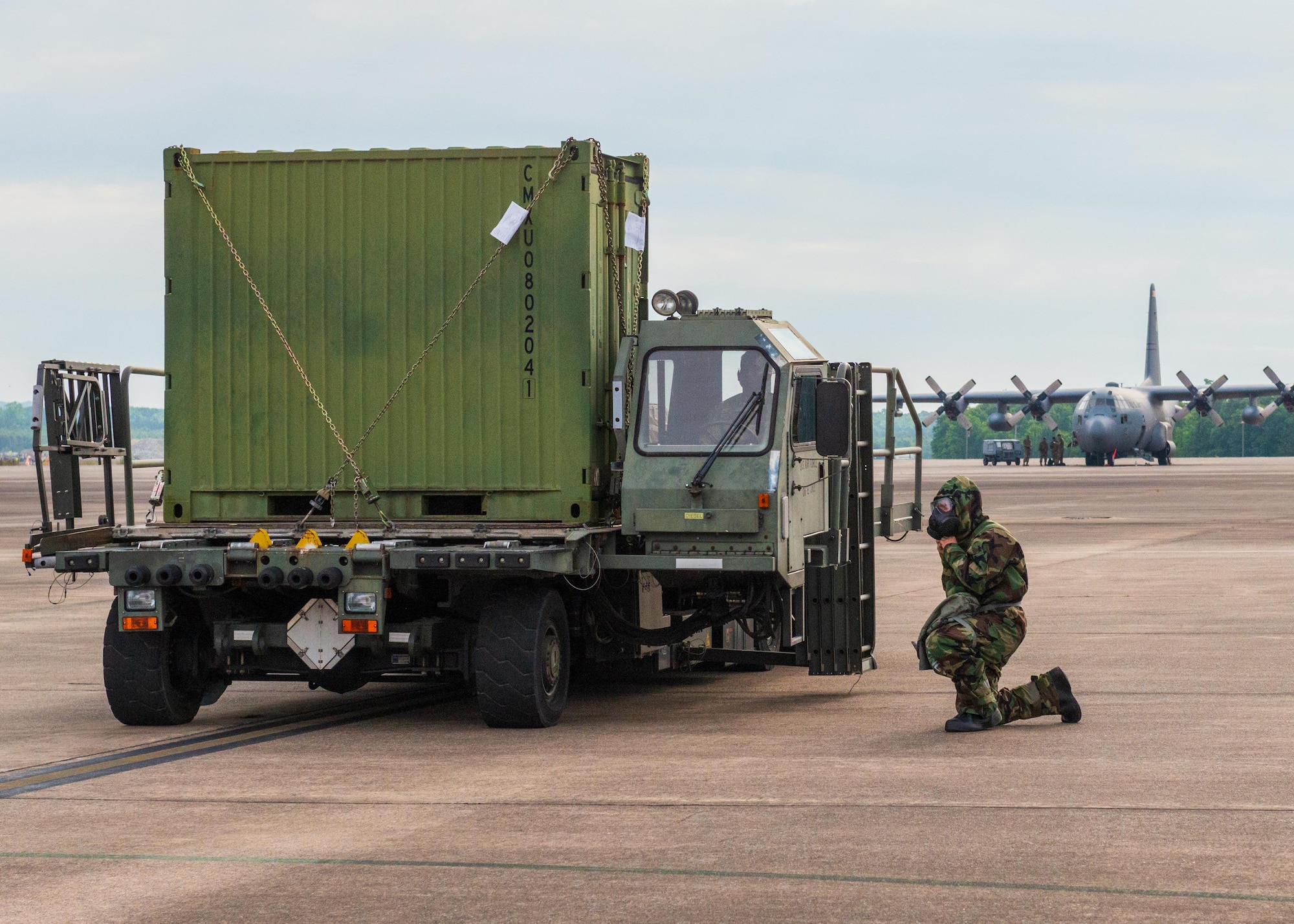 An Airman spots and guides large equipment being loaded onto aircraft while in personal protective equipment at Little Rock Air Force Base, Arkansas, June 5, 2021. ‘Port Dawgs’ from the 189th Aerial Port Flight, Air National Guard, and from the 96th Aerial Port Squadron, Air Force Reserve, created a joint training event focused on aerial port operations at Little Rock Air Force Base, Arkansas, June 3-6, 2021. (U.S. Air Force photo by Senior Airman Julia Ford)