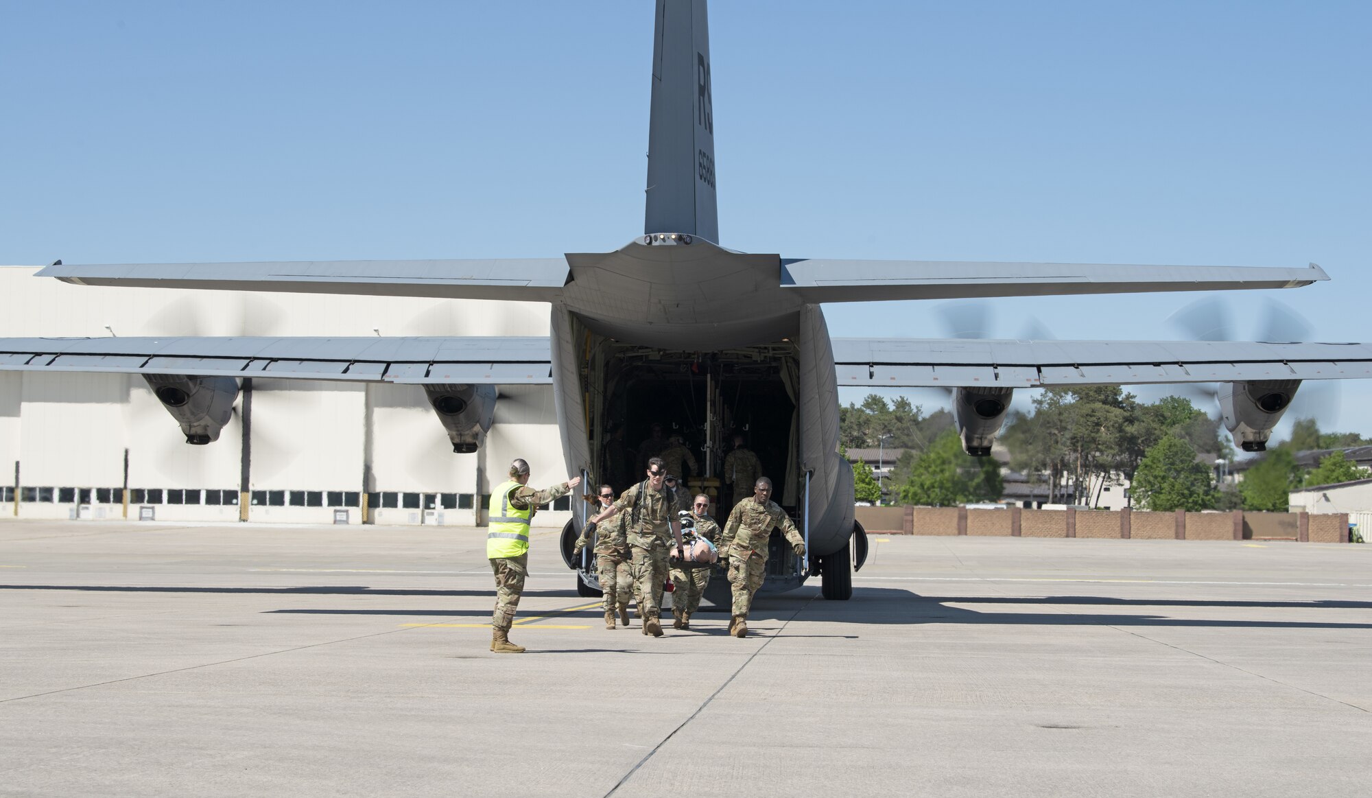52nd Medical Group Airmen transport a simulated casualty off a C-130J Super Hercules assigned to the 86th Airlift Wing during exercise Saber Guardian 21 at Ramstein Air Base, Germany, June 2, 2021. The exercise demonstrated the U.S. Air Force’s capacity to function in a NATO multinational deployed environment. (U.S. Air Force photo by Tech. Sgt. Tony Plyler)