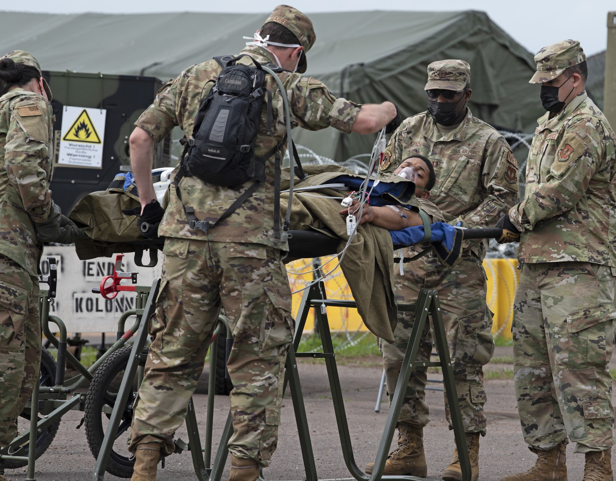 52nd Medical Group Airmen attend to a simulated casualty during Saber Guardian 21 at Baumholder, Germany, June 3, 2021. The Airmen supported the exercise by providing rapid response en-route patient staging for Aeromedical Evacuation in support of contingency operations. (U.S. Air Force photo by Tech. Sgt. Tony Plyler)