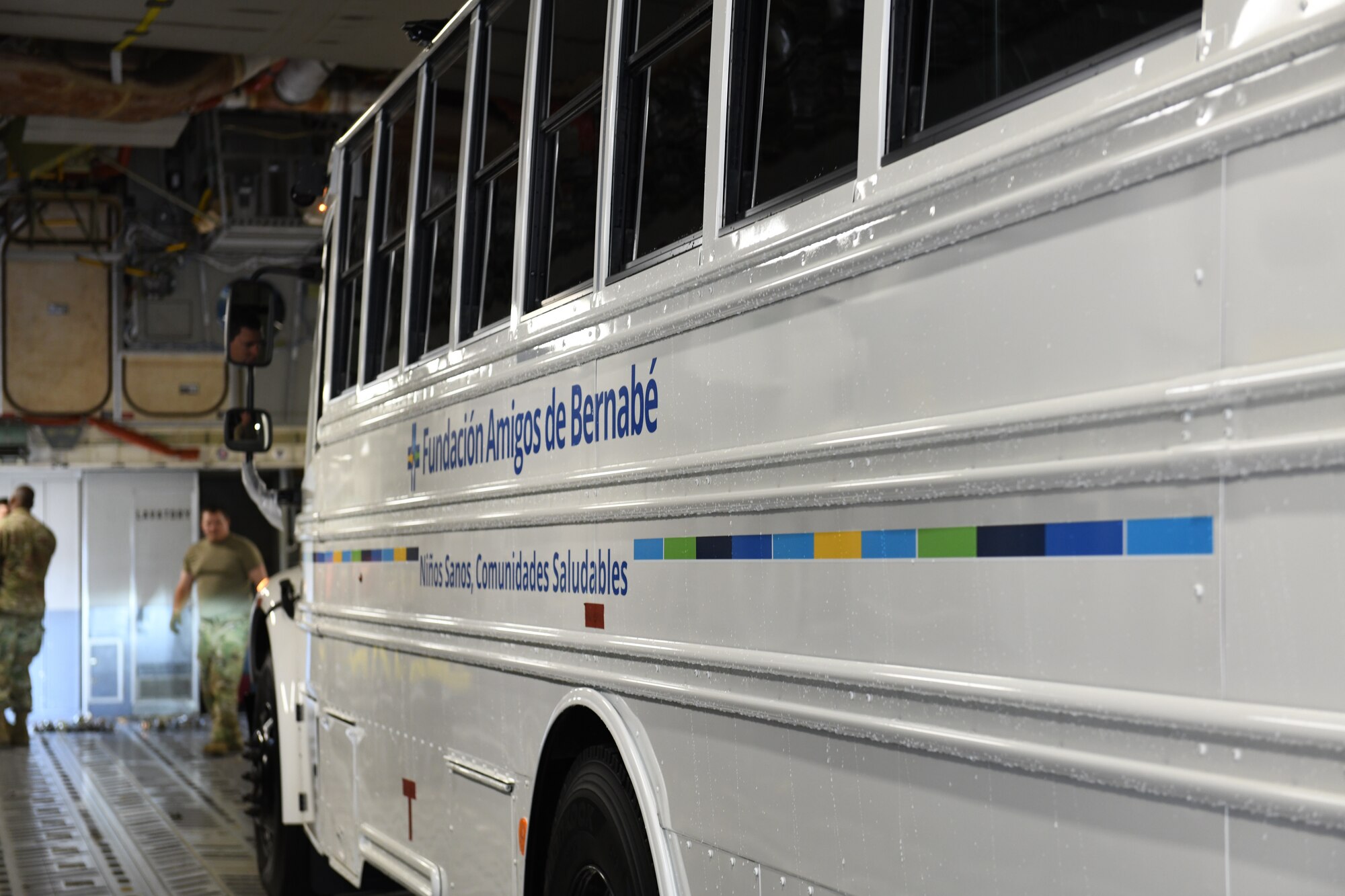 A donated, 44-passenger bus, is loaded onto a C-17 Globemaster III aircraft at the North Carolina Air National Guard (NCANG) Base, Charlotte Douglas International Airport, June 4, 2021. The NCANG works closely with the Denton Humanitarian Assistance Program to move donated relief items like furniture, vehicles, clothing, and food to countries following natural disasters. The 44-passenger bus will be flown to Charleston, S.C. and then to Honduras.