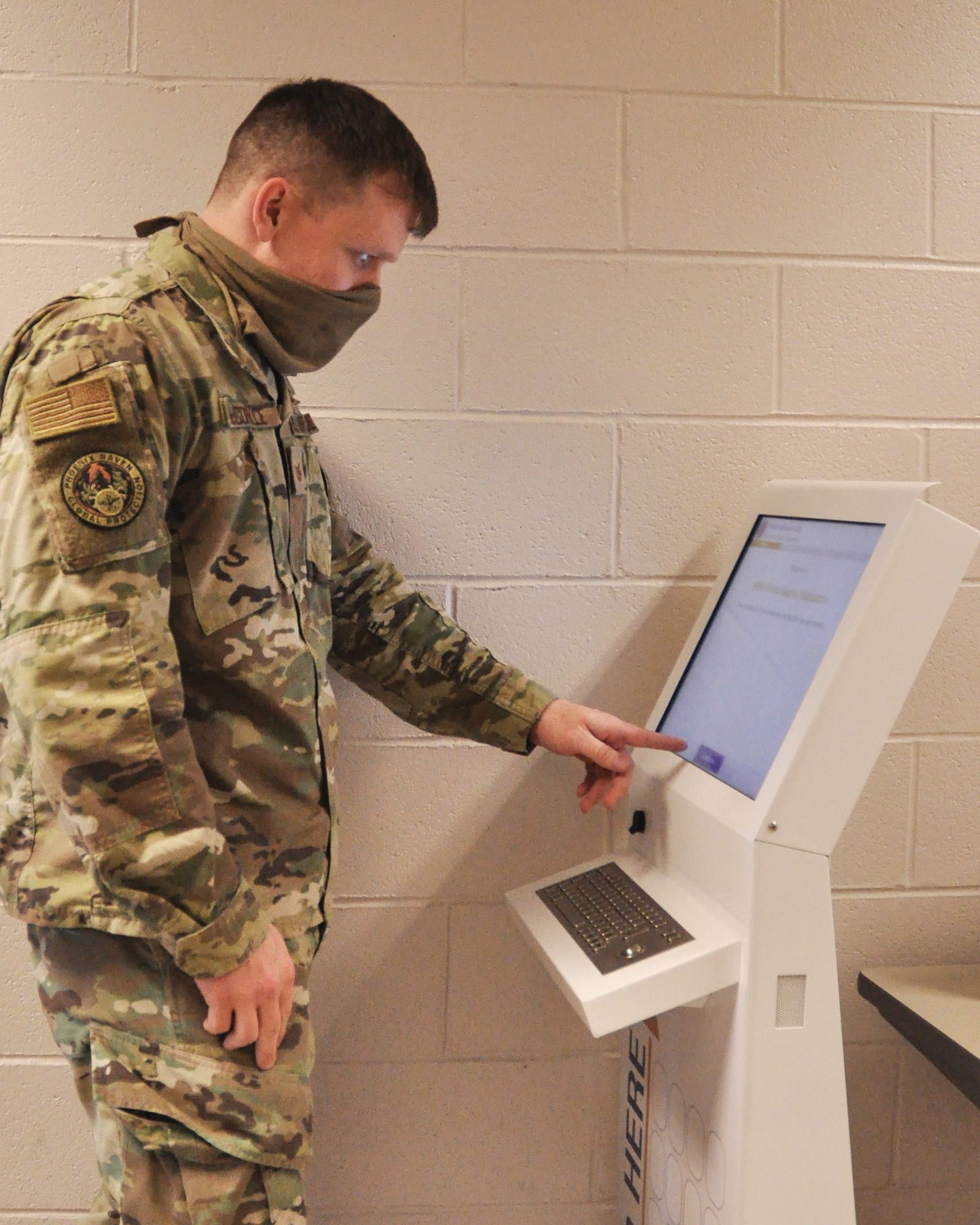 Tech. Sgt. Jacob McCorkle, 445th Security Forces Squadron, signs in via the new kiosk located in the hallway by the personnel office, building 4014. Customers seeking services from the 445th Force Support Squadron are greeted by a new, digital sign in system.