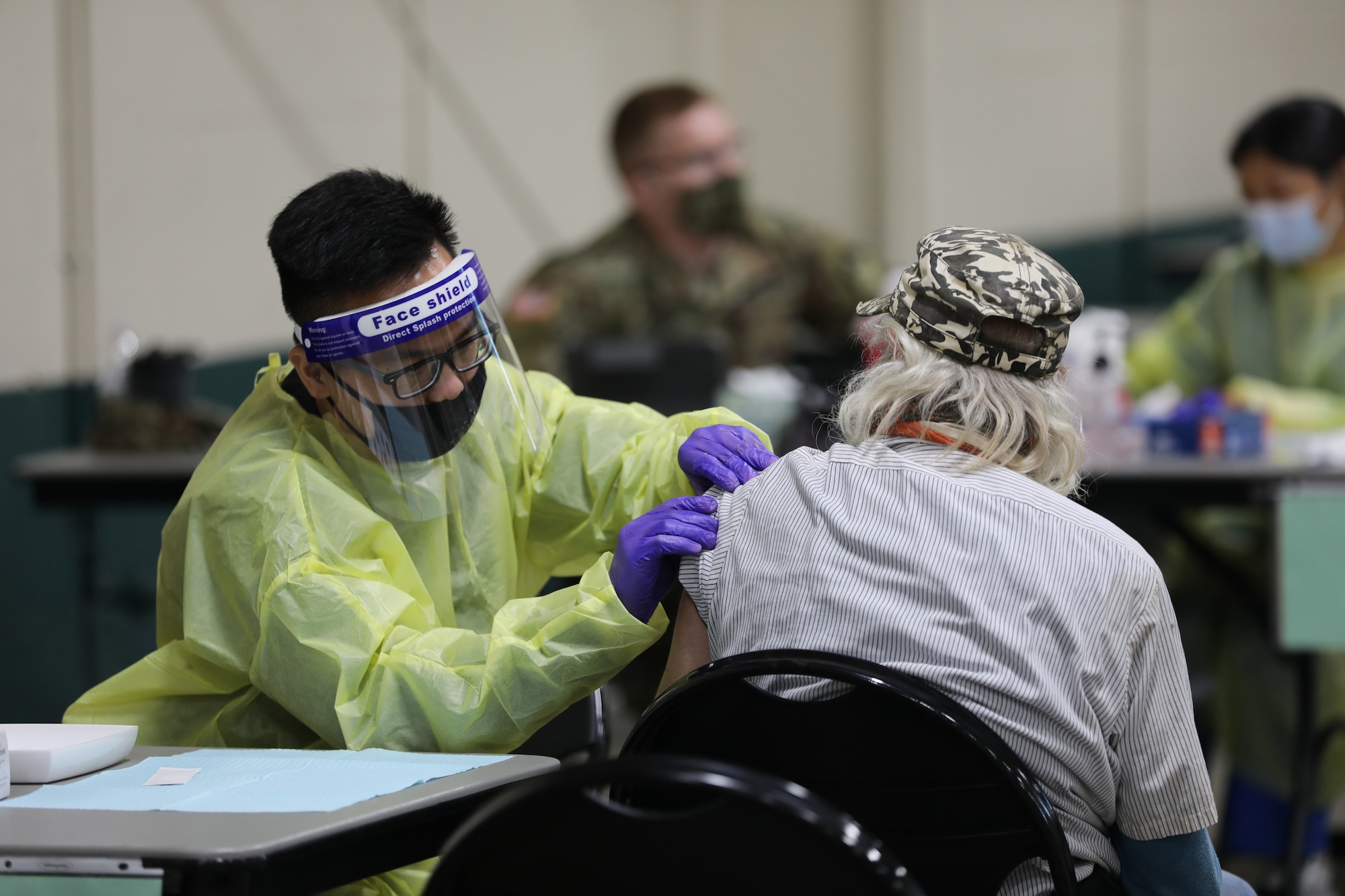 U.S. Army Spc. Corey Lee of the California Army National Guard’s 270th Military Police Company, Joint Task Force 115, gently administers the COVID-19 vaccine to an elderly resident of Yuba County, California, March 26, 2021 at the Yuba-Sutter Fairgrounds in Yuba City. Cal Guard activated special Collection, Transportation and Analysis Teams (CTAT) to help inoculate California communities, centering on areas where the public, especially elderly residents, cannot travel long distances to receive COVID vaccines. (U.S. Army National Guard photo by Staff Sgt. Eddie Siguenza)