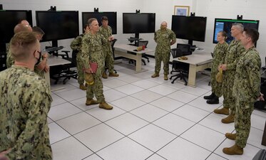 PENSACOLA, Fla. (June 3, 2021) Rear Adm. Mike Vernazza, (center) commander of Naval Information Warfighting Development Center (NIWDC) along with Master Chief Cryptologic Technician (Technical) Kristalina Greene (3rd from right), NIWDC’s senior enlisted leader, participate in a Multipurpose Reconfigurable Training System 3D® (MRTS 3D®) technology training device demonstration and discussion with staff at the Center for Information Warfare Training and Information Warfare Training Command (IWTC) Corry Station. The two visited for a familiarization brief and tour of CIWT and IWTC Corry Station to review information warfare (IW) training initiatives and discuss current and future training for the Navy’s rapidly changing IW missions, capabilities and roles. (U.S. Navy photo by Glenn Sircy)