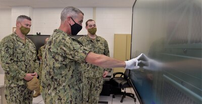 PENSACOLA, Fla. (August 20, 2020) Rear Adm. Pete Garvin, commander, Naval Education and Training Command (NETC), performs a simulated fleet maintenance procedure on the Multipurpose Reconfigurable Training System 3D® (MRTS 3D®) technology training device at Information Warfare Training Command (IWTC) Corry Station. Garvin, along with NETC Force Master Chief Matthew Harris, visited for a familiarization brief and tour of the Center for Information Warfare Training (CIWT) and IWTC Corry Station onboard Naval Air Station Pensacola Corry Station, Pensacola, Florida. The visit offered an opportunity to update them on CIWT / IWTC Corry Station training and development approaches for building a talented fleet through initiatives, such as Ready, Relevant Learning, that take recruits from "street to fleet" and transform civilians into highly skilled, operational, and combat-ready information warfare warfighters.