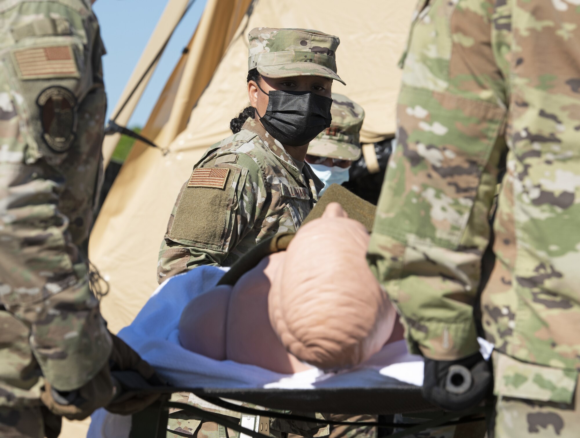 U.S. Air Force Master Sgt. Shanae Gallashaw, 52nd Medical Group Primary Care flight chief, prepares to load a manikin onto a medical ambulance bus June 1, 2021, at Baumholder, Germany. Gallashaw was part of a 16 member En-Route Patient Staging System (ERPSS) team during exercise Saber Guardian 21. (U.S. Air Force photo by Tech. Sgt. Tony Plyler)