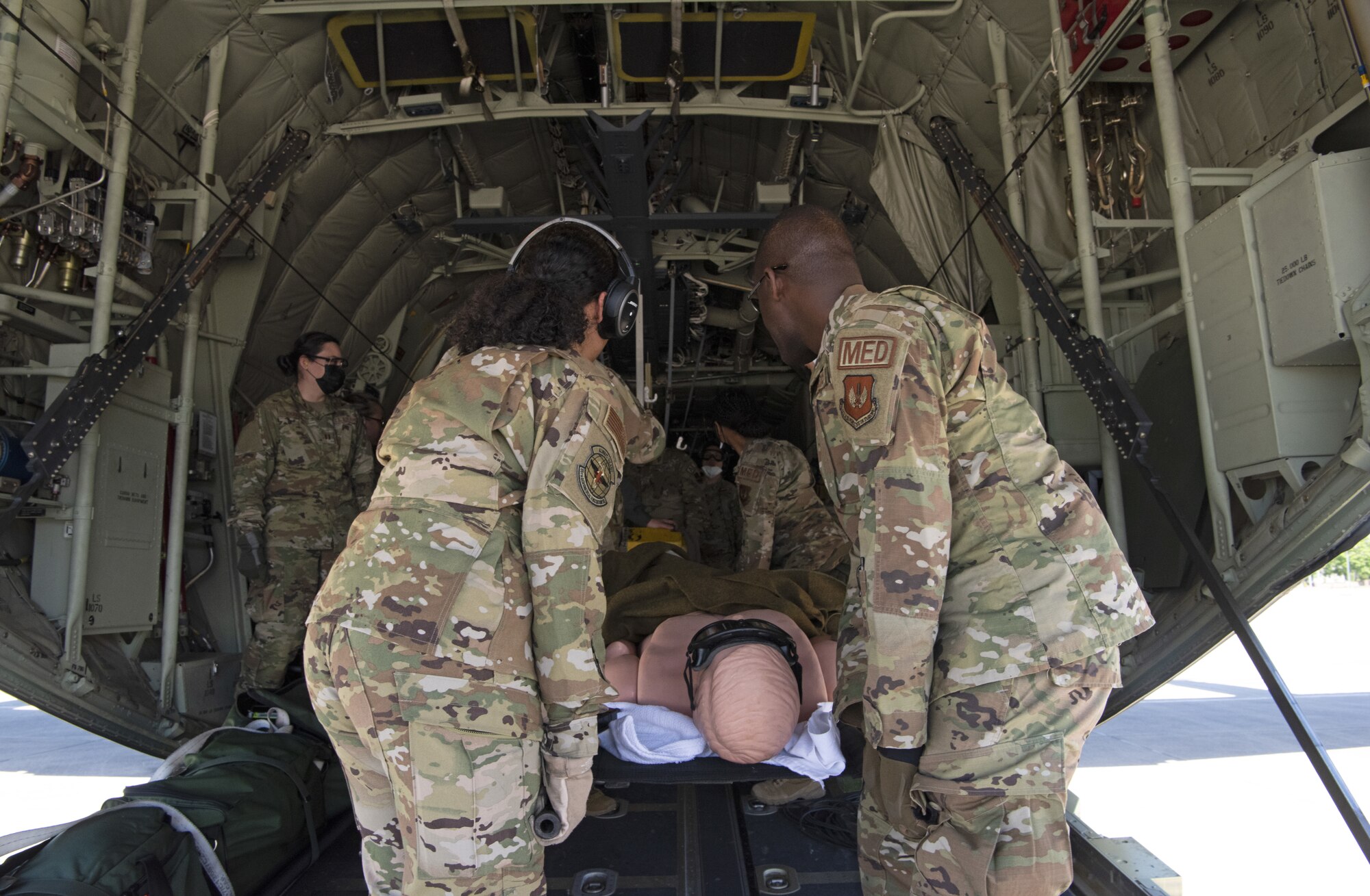 Airmen board a C-130J Super Hercules assigned to the 86th Airlift Wing with a simulated casualty during exercise Saber Guardian 21 at Ramstein Air Base, Germany, June 2, 2021. Airmen with the 52nd Medical Group, Spangdahlem Air Base, Germany and the 86th Aeromedical Evacuation Squadron, Ramstein Air Base, Germany,  performed aeromedical evacuation missions on June 1 and June 2. (U.S. Air Force photo by Tech. Sgt. Tony Plyler)