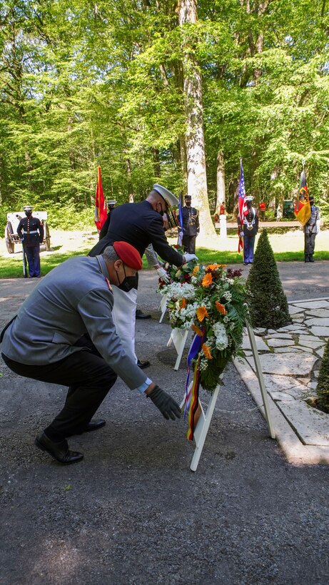 Maj. Gen. Tracy King, U.S. Marine Corps Forces Europe and Africa commander, and Brig. Gen. Michael Podzus, German Army, look at their wreaths during a ceremony at the Iron Mike statue near Belleau, France, May 30, 2021. The ceremony was held Memorial Day weekend in commemoration of the 103rd anniversary of the battle of Belleau Wood, conducted to honor the legacy of service members who gave their lives in defense of the United States and European allies.