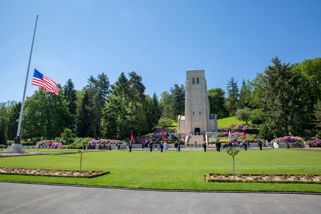 Vistors gather during a ceremony at Aisne-Marne American Cemetery in Belleau, France, May 30, 2021. The ceremony was held Memorial Day weekend in commemoration of the 103rd anniversary of the battle of Belleau Wood, conducted to honor the legacy of service members who gave their lives in defense of the United States and European allies.
U.S. Marines and Sailors from Marine Corps Forces Europe and Africa, 5th Marine Regiment, 6th Marine Regiment, 1st Marine Division band, U.S. Soldiers from the Army 26th Infantry Division, 2nd Infantry Division representatives, German and French service members, and local officials participated in the ceremony. The joint color guard included the U.S. Army colors, a first for the historic ceremony. This was the first time since the battle over a century ago that U.S. Marine Corps, U.S. Army, U.S. Navy, French, and German service members were all present for the ceremonies.
