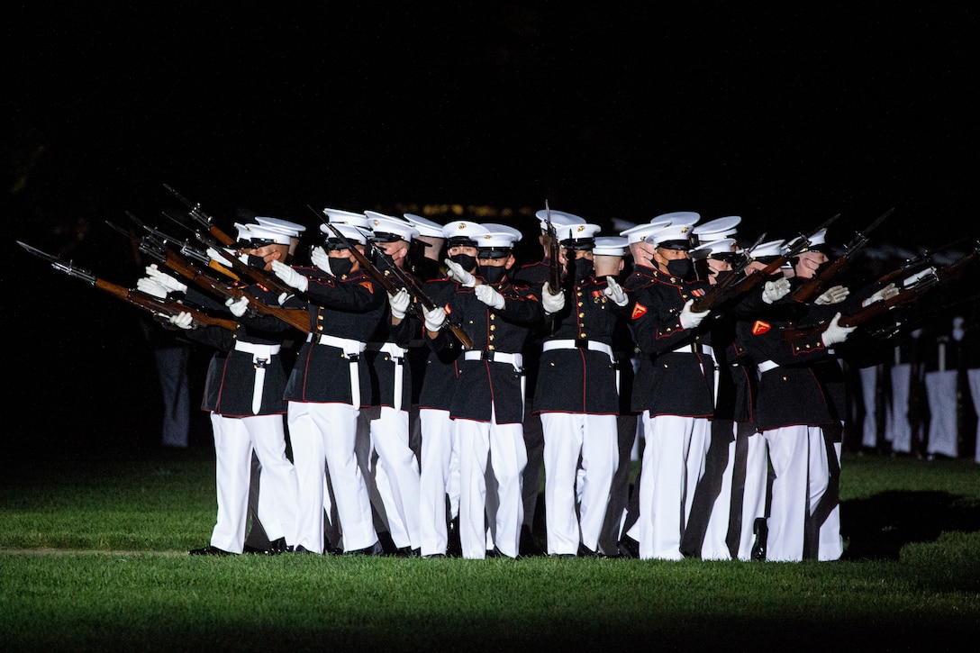 Marines with the Silent Drill Platoon perform their “bursting bomb” sequence during the Friday Evening Parade at Marine Barracks Washington, June 4, 2021. The guest of honor for the evening was The Honorable Michèle A. Flournoy, 9th Undersecretary of Defense for Policy, and the hosting official for the evening was Lt. Gen. Charles G. Chiarotti, Deputy Commandant for Installations and Logistics. (U.S. Marine Corps photo by Lance Cpl. Mark A. Morales)