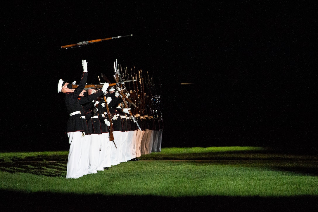 Marines with the Silent Drill Platoon perform their “long line” sequence during the Friday Evening Parade at Marine Barracks Washington, June 4, 2021. The guest of honor for the evening was The Honorable Michèle A. Flournoy, 9th Undersecretary of Defense for Policy, and the hosting official for the evening was Lt. Gen. Charles G. Chiarotti, Deputy Commandant for Installations and Logistics. (U.S. Marine Corps photo by Lance Cpl. Tanner D. Lambert)