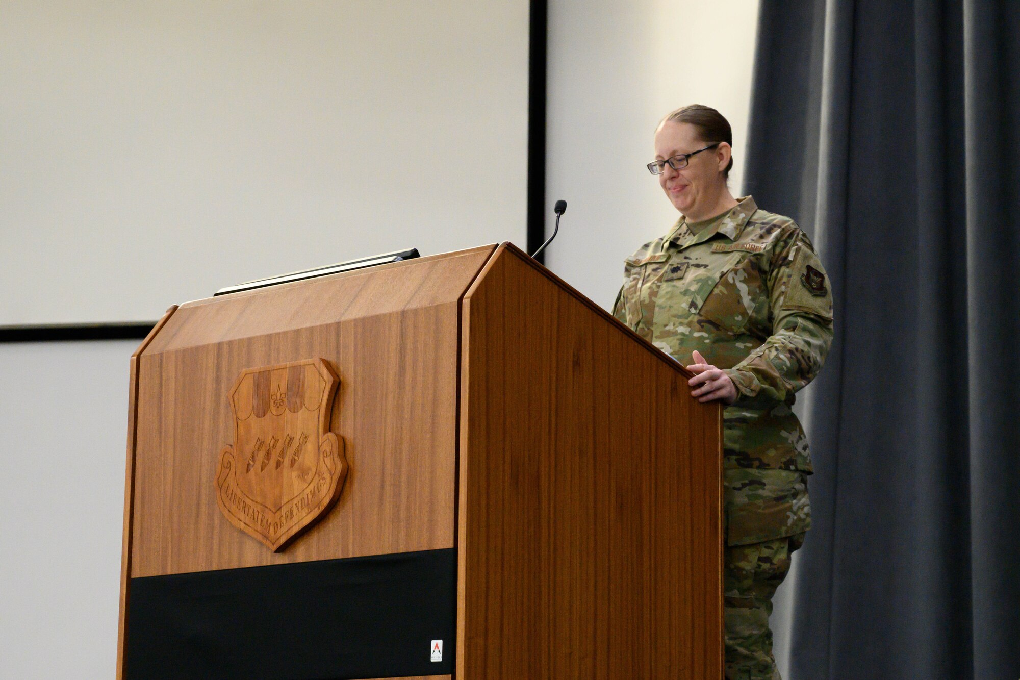 Airman speaks at podium.