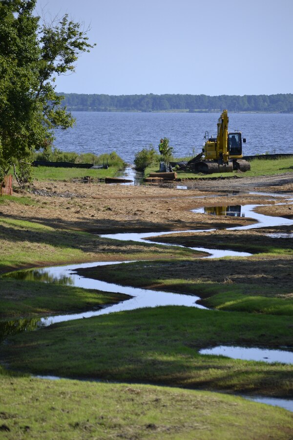 A stream in the process of being restored in the Grant’s Landing residential housing area, filters water that runs off into the Neuse River at Marine Corps Air Station (MCAS) Cherry Point, North Carolina, July 29, 2015. The Environmental Affairs Department (EAD) responded to concrete lined ditched carrying contaminants to the Neuse River by removing the concrete ditches, restoring the natural curves in the streamline. They put down coconut fiber matting to give the banks steadiness for the planted shrubbery, grasslands and trees to filter water from the storm drains before making it to the streamline.

(U.S. Marine Corps Courtesy Photo by: Jessica Guilianelli)